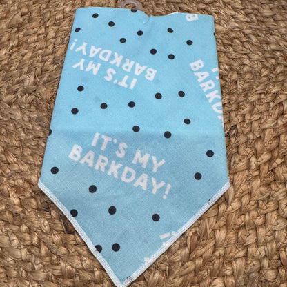 Blue bandana with 'It's My Barkday!' text on a woven surface