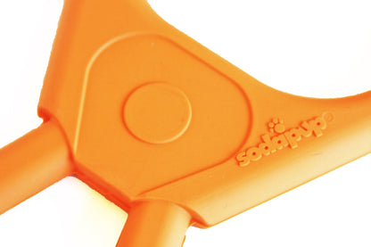 Rubber dog toy from SodaPup, designed for heavy chewers, featuring a pop top for interactive play, made in the USA.